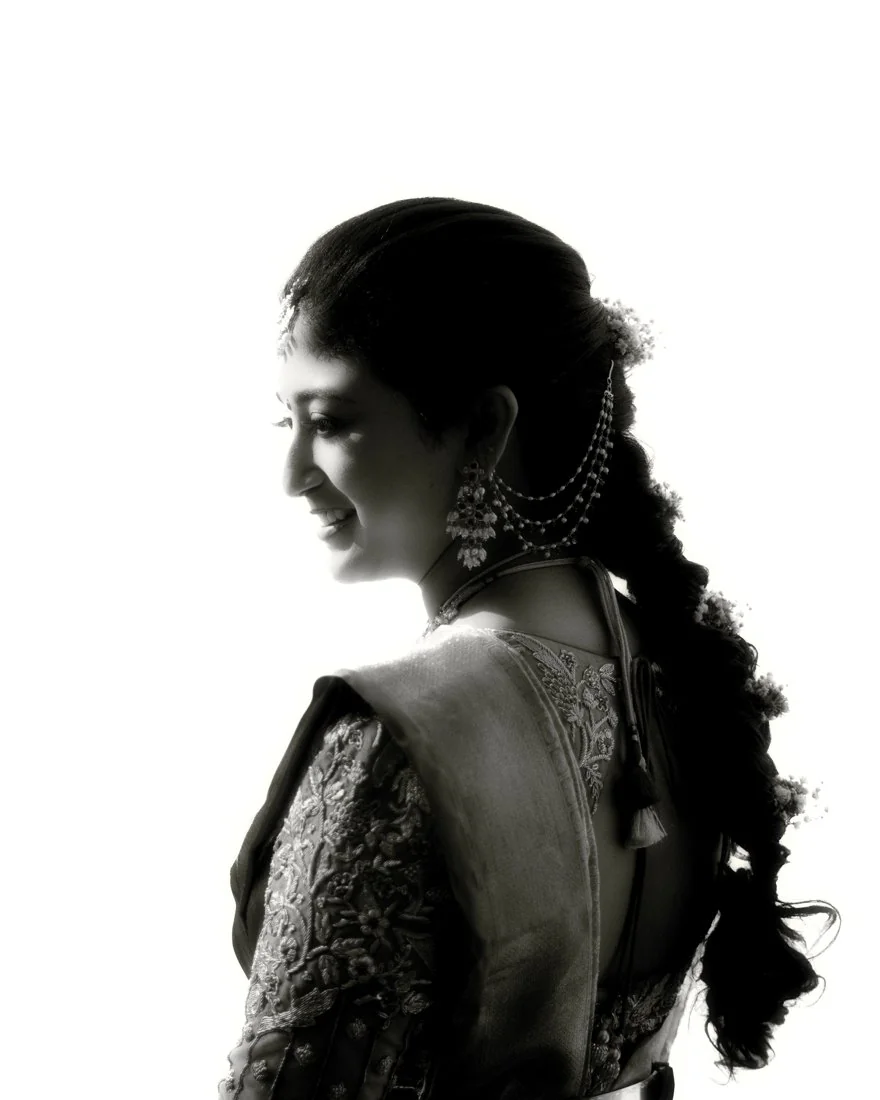 A woman looking back in a black-and-white bridal portrait