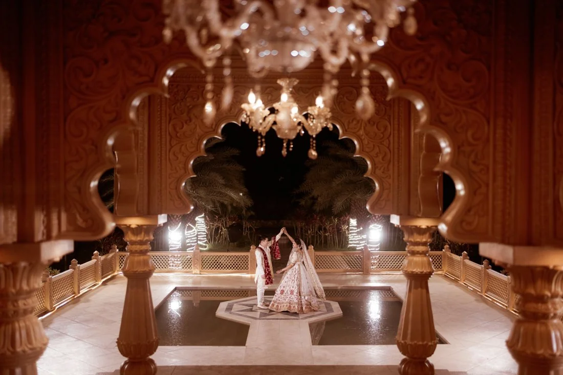 A couple standing within ceremonial architecture